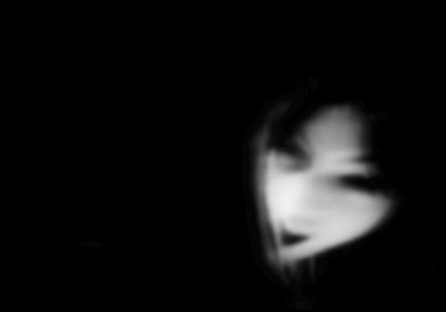 Ghostly figure on plain backdrop