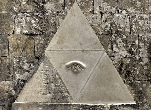 Eye of Providence symbol etched in limestone
