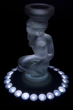 Candlestick glass statue of the woman on black background
