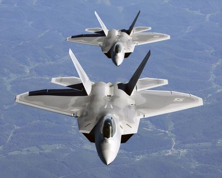 Lt. Col. James Hecker (front) and Lt. Col. Evan Dertein line up their F/A-22 Raptor aircraft behind a KC-10 Extender to refuel while en route to Hill Air Force Base, Utah. Colonel Hecker commands the first operational Raptor squadron -- the 27th Fighter Squadron at Langley Air Force Base, Va. The unit went to Hill for operation Combat Hammer, the squadron's first deployment, Oct. 15. The deployment has a twofold goal: complete a deployment and to generate a combat-effective sortie rate away from home. ** Credit:  TSgt Ben Bloker / USAF / yaymicro.com **