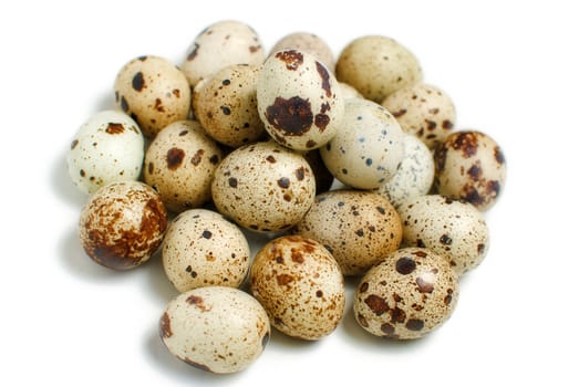 Pile of quail eggs isolated on white background