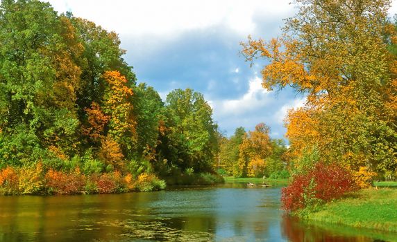 Intensive colors of autumn landscape with the lake