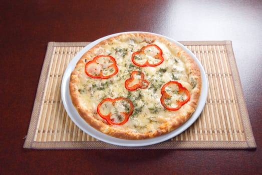 Tasty Italian pizza  on plate.Italian kitchen.paprika