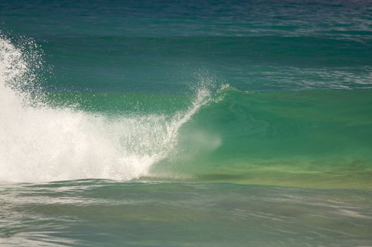 Dramatic Shorebreak Wave on a clear morning.