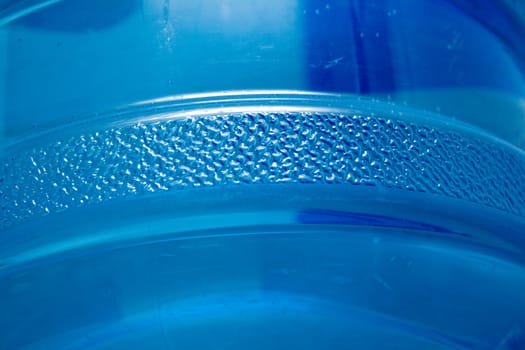 Blue plastic bottle with water. A background, macro