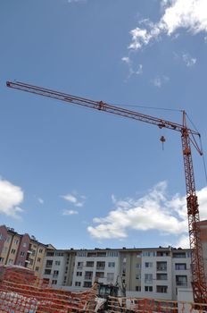 cranes on construction site with a background of blue sky 