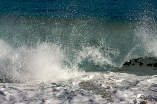 Dramatic Shorebreak Wave on a clear morning.