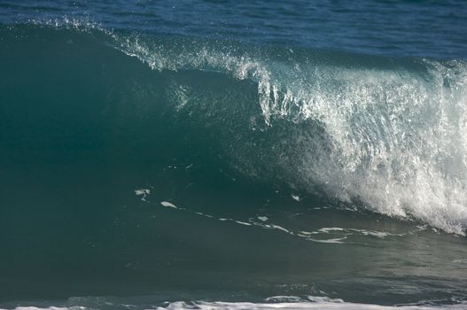 Dramatic Shorebreak Wave on a clear morning.