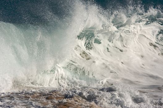 Dramatic Shorebreak Wave on a clear morning.