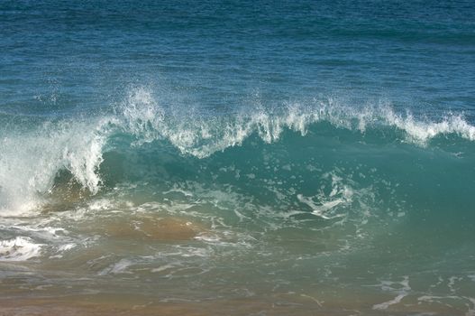 Dramatic Shorebreak Wave on a clear morning.