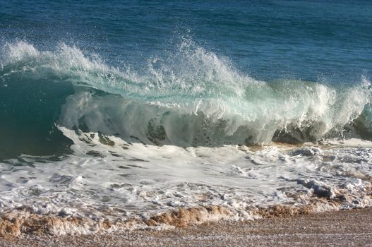 Dramatic Shorebreak Wave on a clear morning.