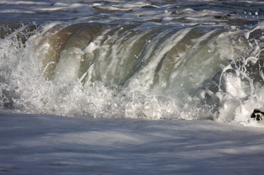 Dramatic Shorebreak Wave on a clear morning.