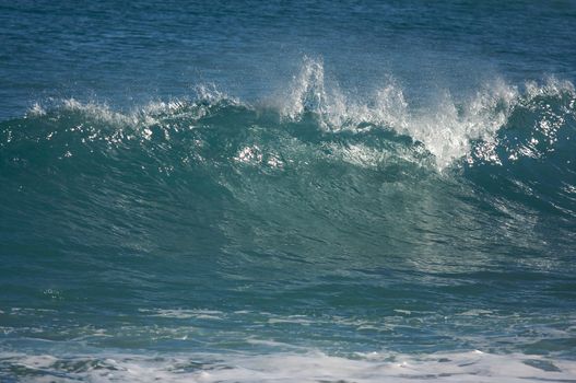 Dramatic Shorebreak Wave on a clear morning.