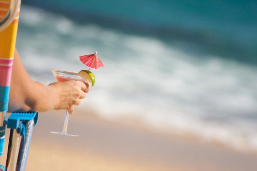 Woman Relaxing on Beach with Tropical Drink.