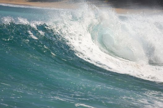 Dramatic Shorebreak Wave on a clear morning.