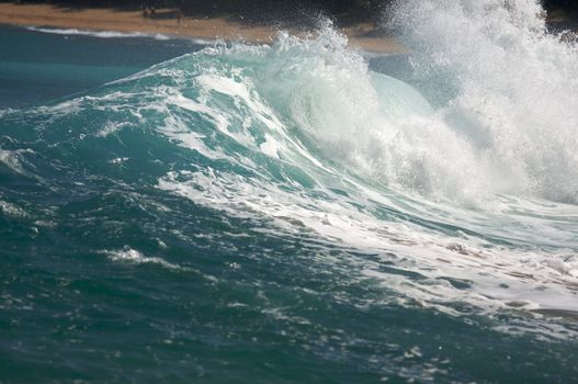 Dramatic Shorebreak Wave on a clear morning.