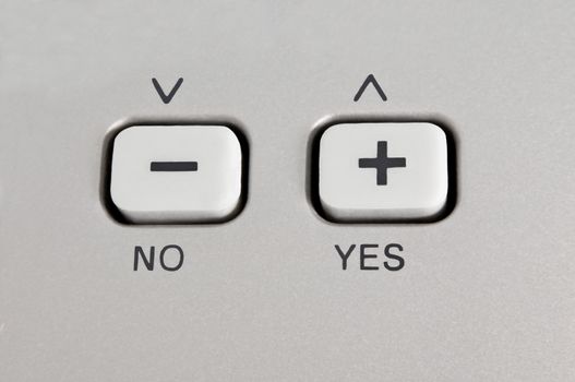 Close up of a button control panel with arrows and the words 'yes' and 'no'.