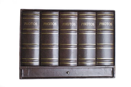 Five photo books in mini bookcase isolated on white background (front view)