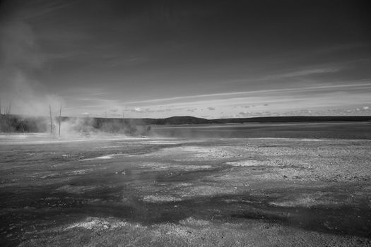 Geothermal hot springs on the shore of Yellowstone Lake in black and white