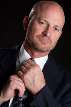 Businessman adjusting necktie