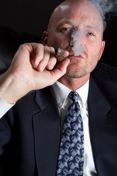Business man smoking cigar