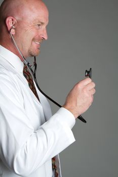 Bald doctor holding stethoscope