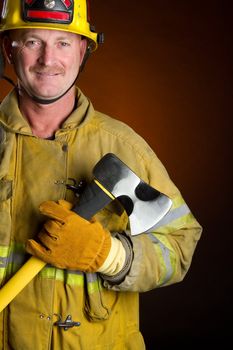 Smiling firefighter holding axe