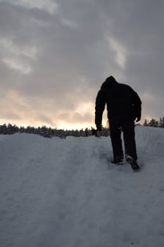 man walking up a hill