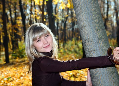 portrait of beautiful smiling young girl in autumn park