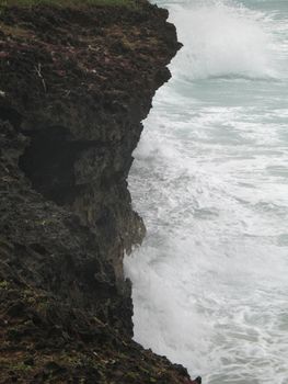 cliff and angry ocean water