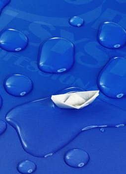 paper boat floating on water drops ,over blue background