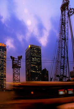 construction cranes on night ove a blue sky