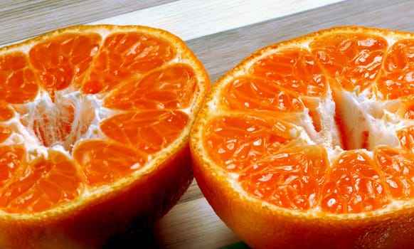 orange mandarin tangerine on wood cutting board