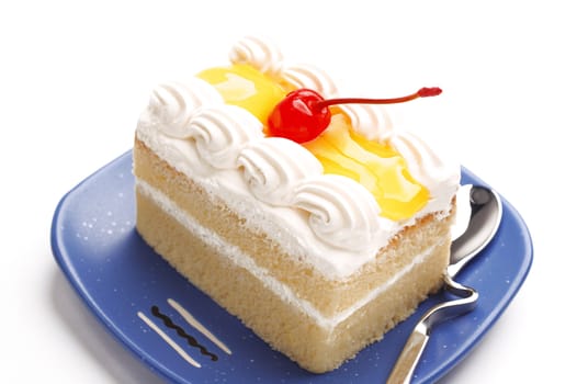 piece of lemon jelly cake with cherry on top ,on white background