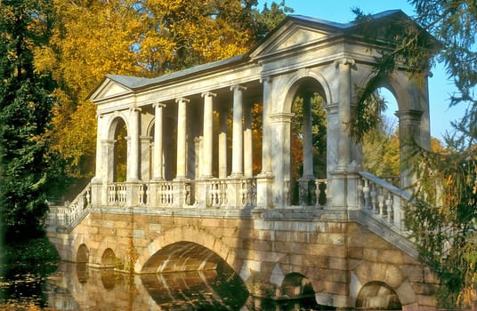 Marble bridge in the autumn park