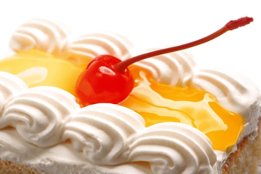 piece of  lemon jelly cake with cherry on top on white background