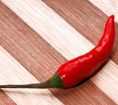 red chili pepper on a wood cutting board