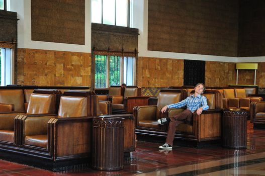 Passenger sleeps in the waiting room of Union Station in Los Angeles