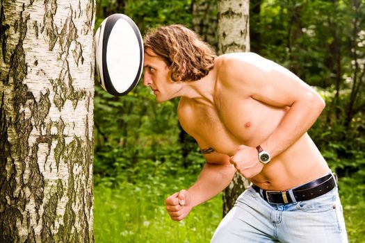 Caucasian strong man playing funny rugby ball outdoors