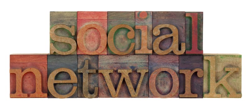social network words in vintage wood letterpress type, stained by color ink, isolated on white