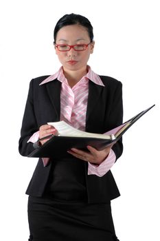 Chinese businesswoman, wearing lady's suit and shirt.  Holding documents, reviewing documents.