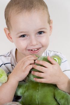 child playing with teddy bear