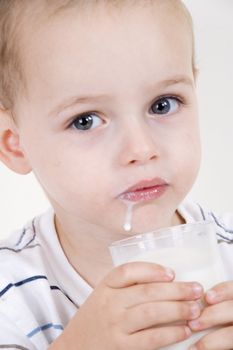 portrait of a little boy drinking milk