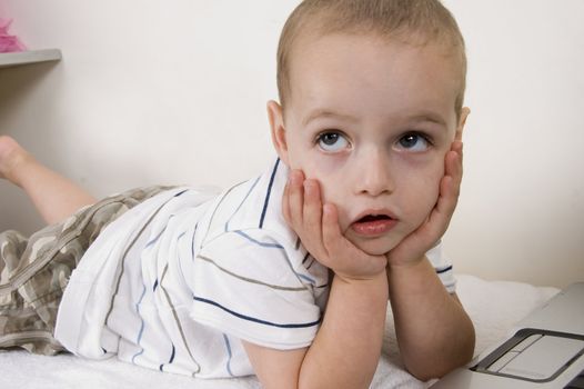 child in thinking pose with chin on hands