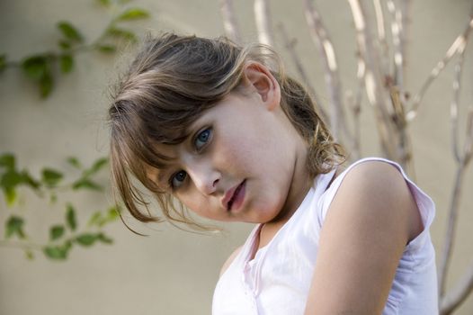 adorable little girl posing in style on natural background