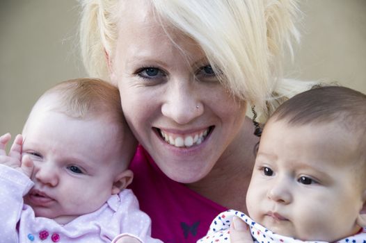 close up beautiful mother posing with her two kids 