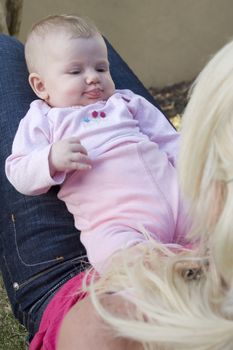 young baby looking at her mother with curiosity
