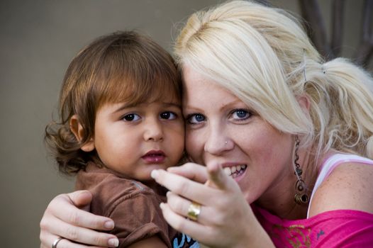 young caucasian lady telling her child to look at camera