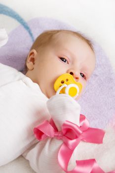 Cute baby girl with pink ribbon