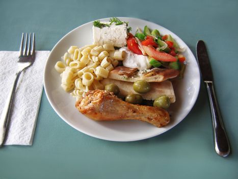 fried chiken with vegetables, cheese and pasta